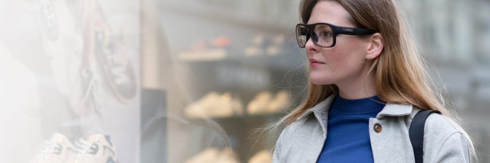 Woman looking at products in a window with Tobii Pro Glasses 3